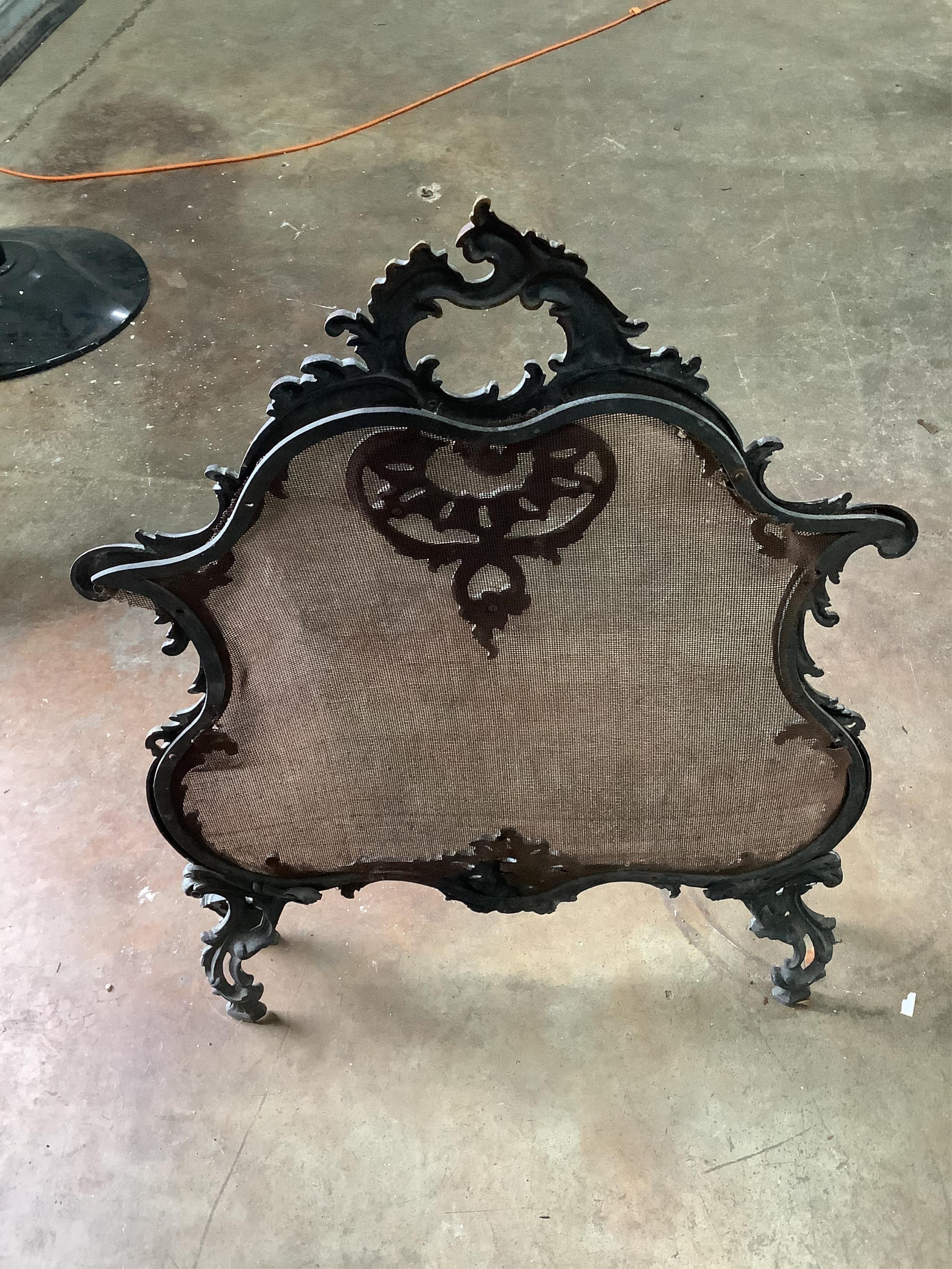 An Adam design brass mounted cast iron fire grate, width 74cm, depth 44cm, height 65cm, together with a brass rococo style mesh firescreen. Condition - poor to fair